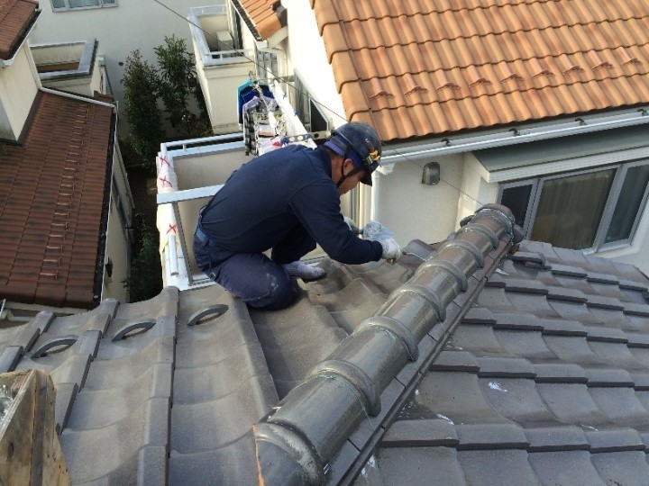 下がり棟の軒先での慎重な作業