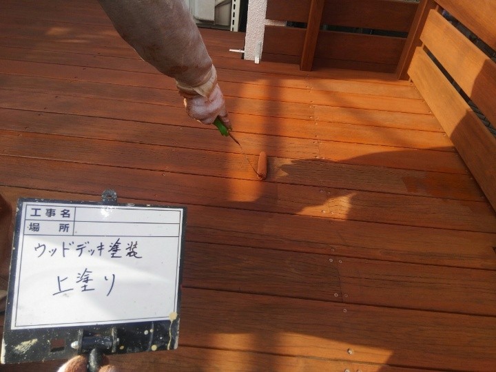 ウッドデッキに上塗り作業する施工風景