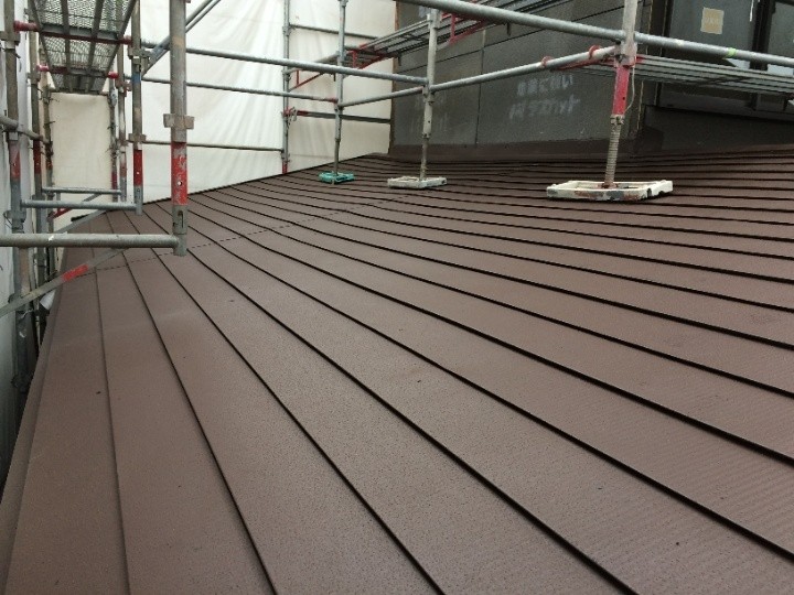 長尺横葺きのカラー鉄板を用いた屋根カバー工法が完工した建物