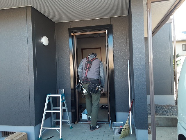 住宅玄関ドアカバー工法リフォームの既存ドア枠に新しいドア枠を取り付けている様子