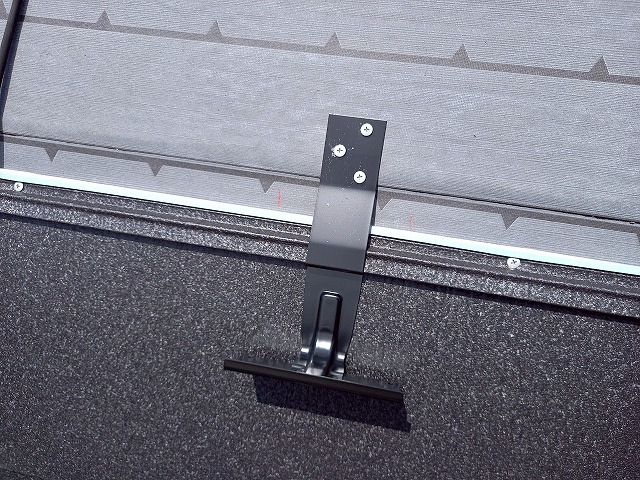 屋根カバー工事で金属屋根にビス留めした雪止め金具