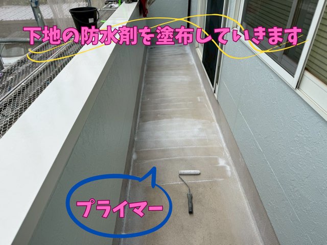 プライマー塗布作業 – 床に接着用プライマーをローラーで塗布している様子