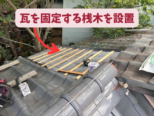 屋根に瓦桟（瓦を引っ掛けるための木材）を設置している様子
