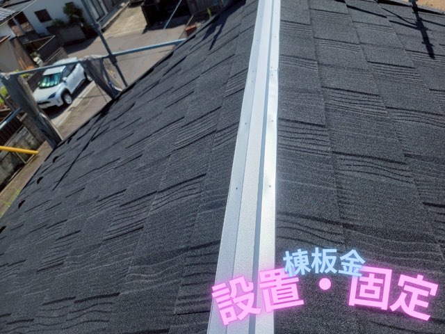 屋根の頂部に銀色の棟板金を設置し固定した様子