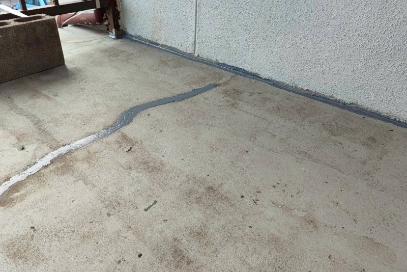 ベランダ床のひび割れと壁際にコーキング