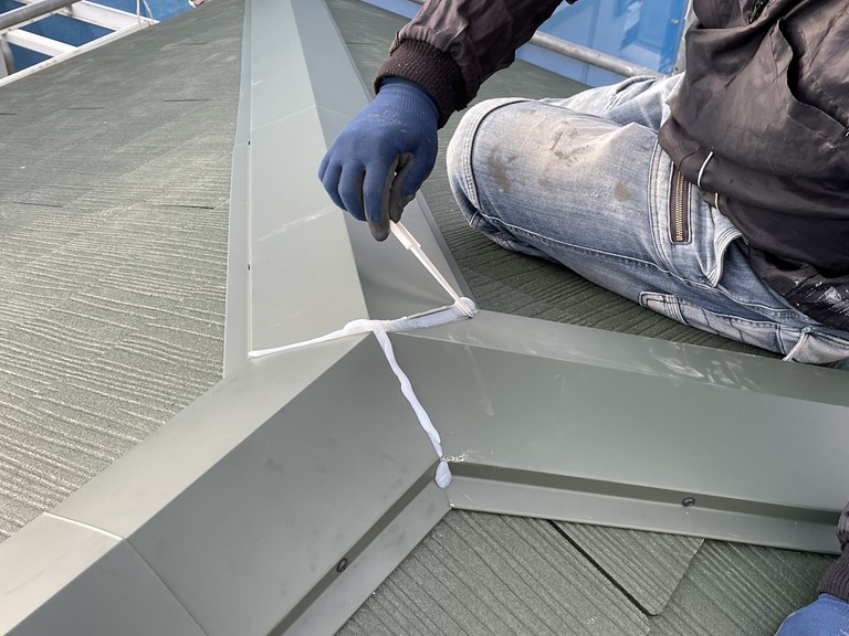 紀の川市で棟板金の取合いにコーキングを充填してヘラでならします