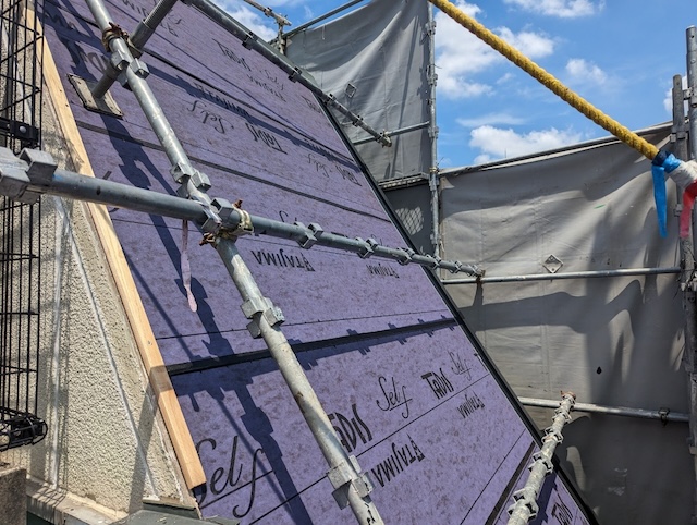 急勾配屋根にタッカー（釘）を使わず強力密着させるTAJIMA製タディスセルフの施工風景