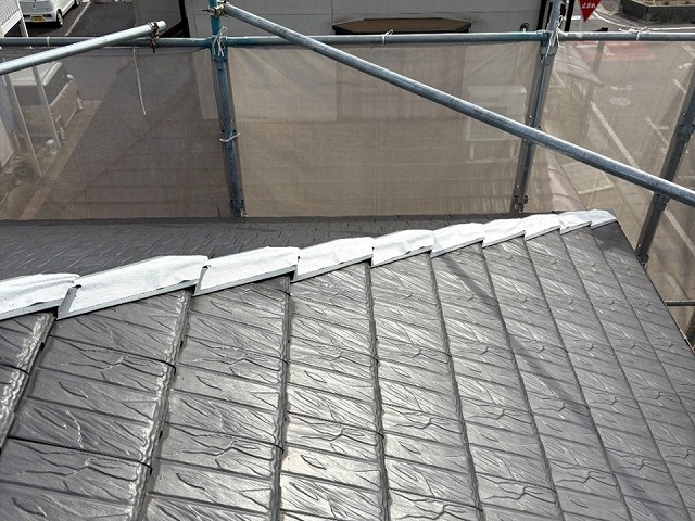 棟部役物取り替え改修工事の隅棟板金役物への防水テープ貼り付け