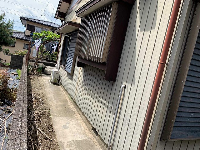 劣化で色あせたトタン外壁の住宅