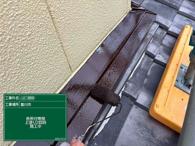 雨押え板金に仕上げ塗料で上塗りを行っている様子
