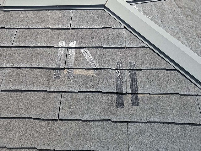 スレート屋根の割れ落下しないようテープで固定している様子