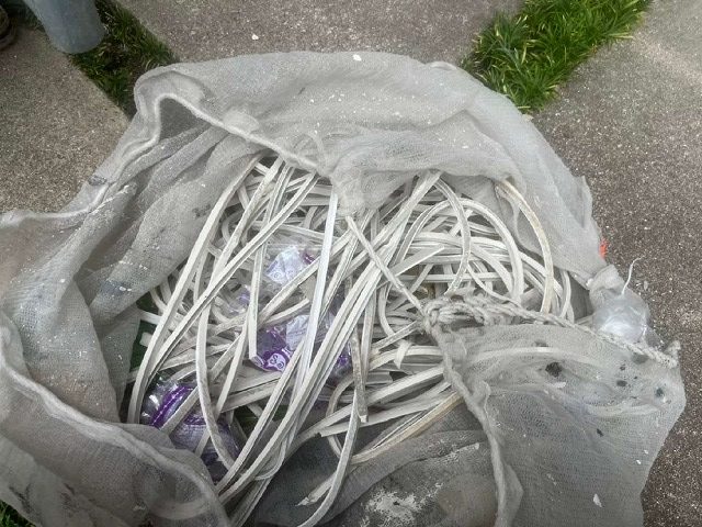 劣化して取り除いたコーキングをゴミ袋でまとめている様子