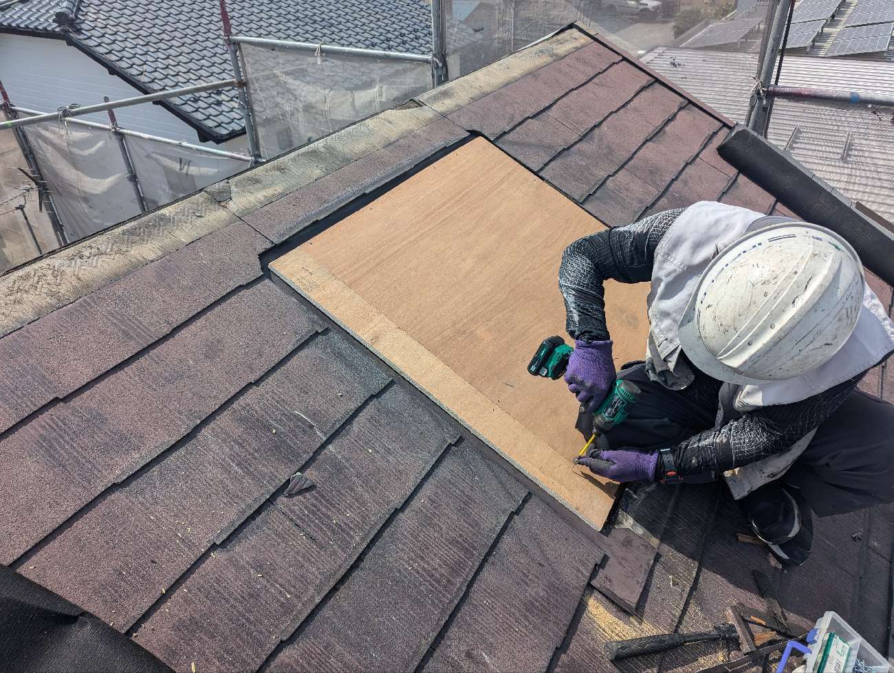 天窓にベニヤ板で蓋をする様子