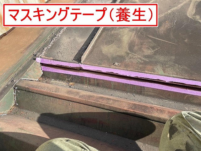 南部町で金属の折板屋根のコーキング作業前に養生（マスキングテープ）をかける様子