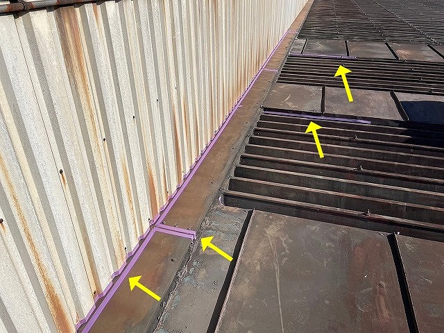 南部町で金属の折板屋根のコーキング作業前に養生（マスキングテープ）をかける様子