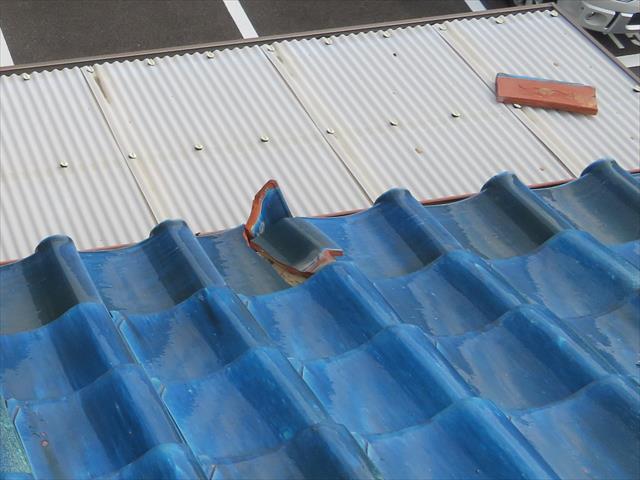 茨木市の地震で大棟が崩れた瓦屋根では、熨斗瓦、紐丸（冠瓦）が滑り落ちて屋根から落ちそうになっている。