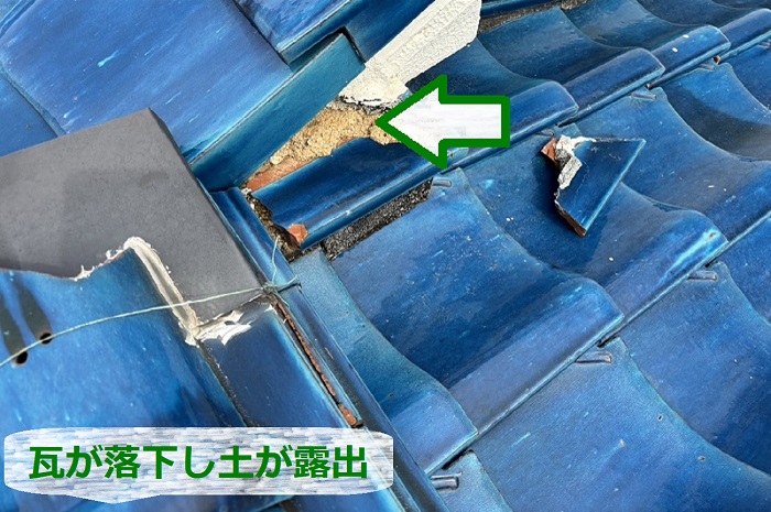 瓦屋根が落下して土が露出している様子