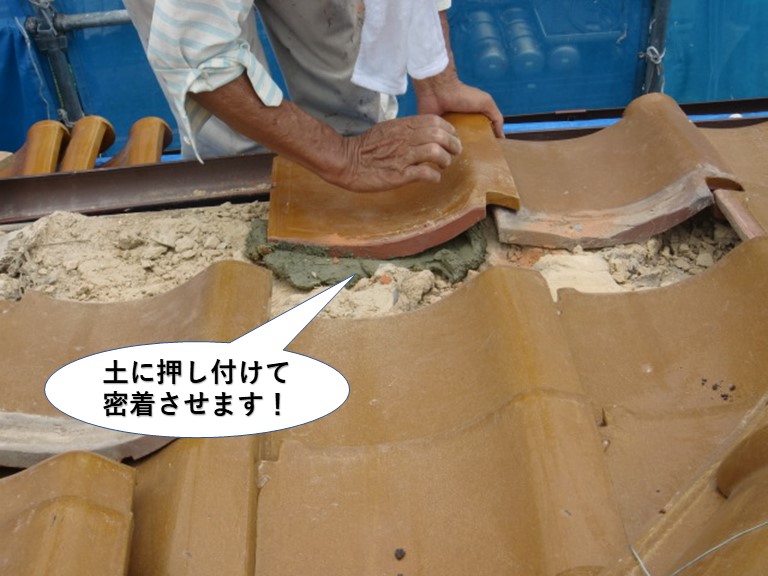 熊取町の軒先瓦を土に押し付けて密着させます
