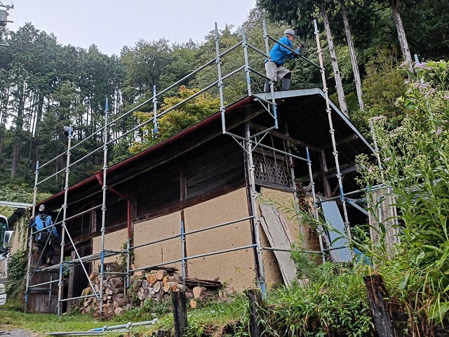 農作業小屋屋根葺き替え工事の足場を組み立てる作業員の様子