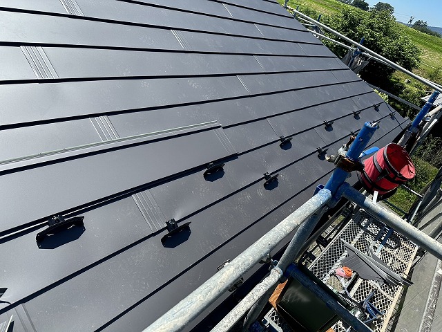 屋根カバー工事でガルバリウム鋼板屋根本体葺きと雪止め金具の取り付け