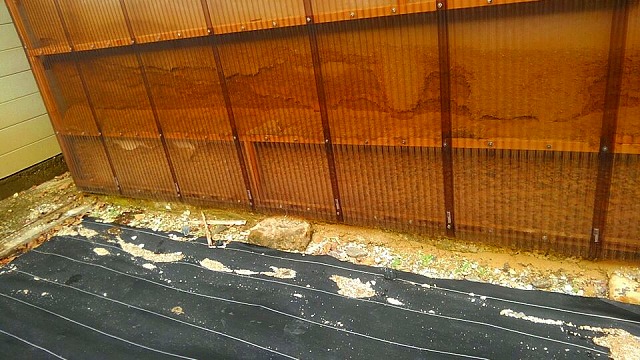 波板と崩れた漆喰壁