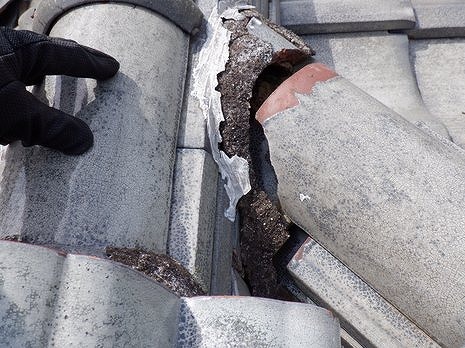 隅棟の冠瓦が劣化した漆喰から抜けている