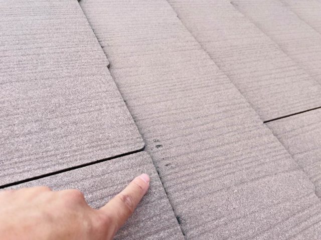 志免町で化粧スレートの傷んだところを指差す職人