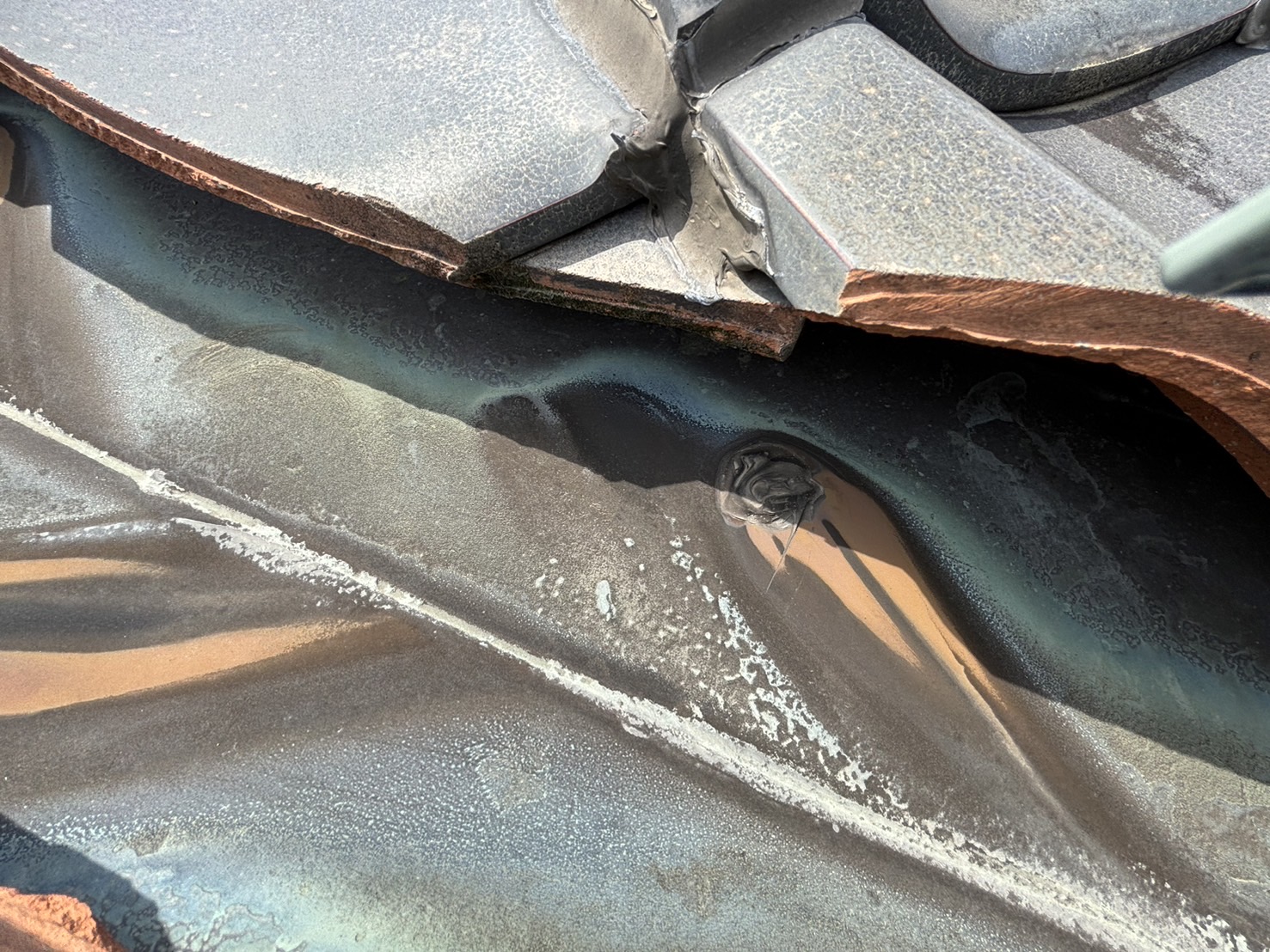 四日市市にて屋根瓦の谷樋板金劣化で穴が開いた状態拡大