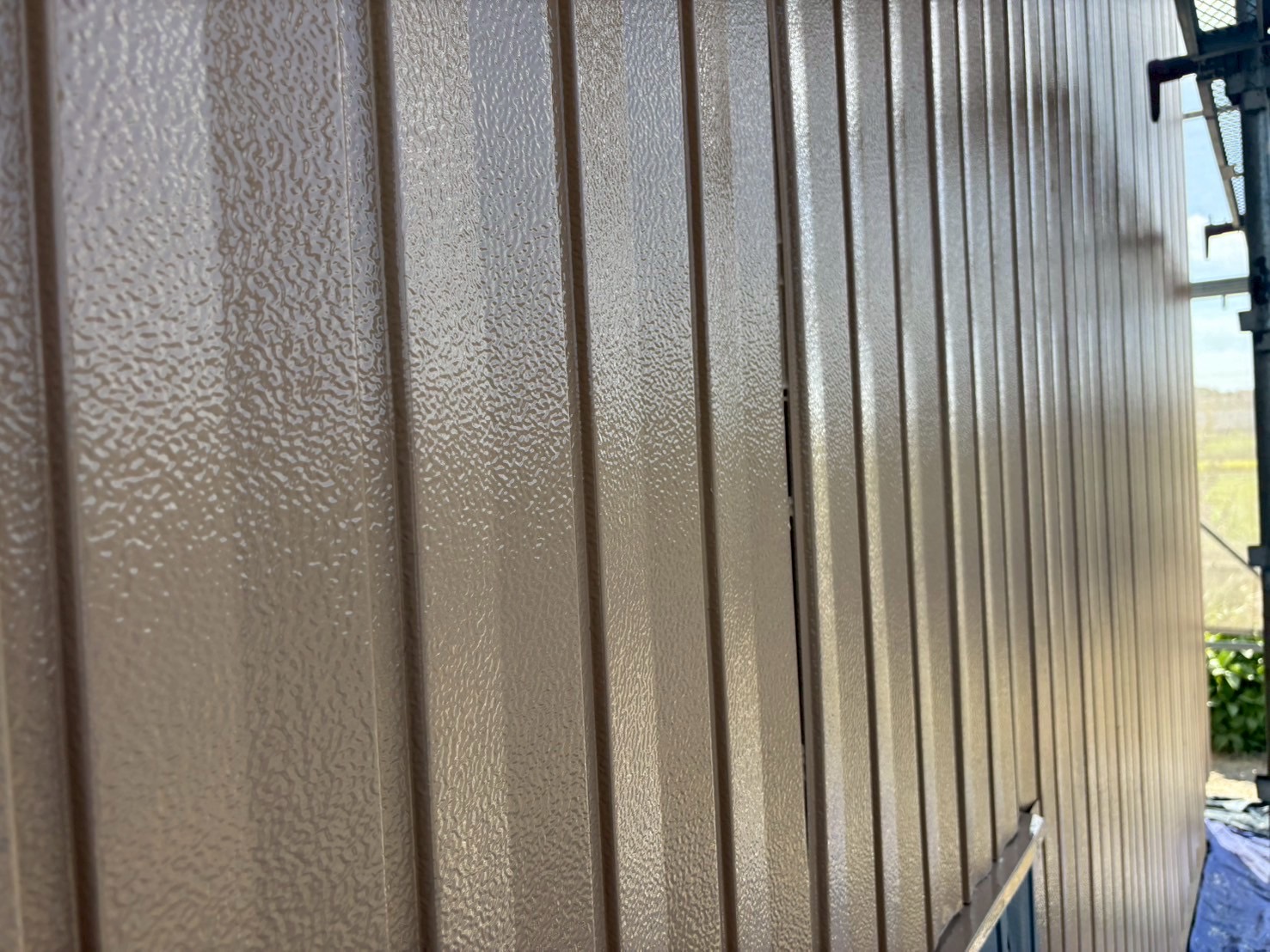 施工前にサビが広がっていた農機具倉庫の角波板金外壁と、塗装後に美しく蘇った外壁の比較写真