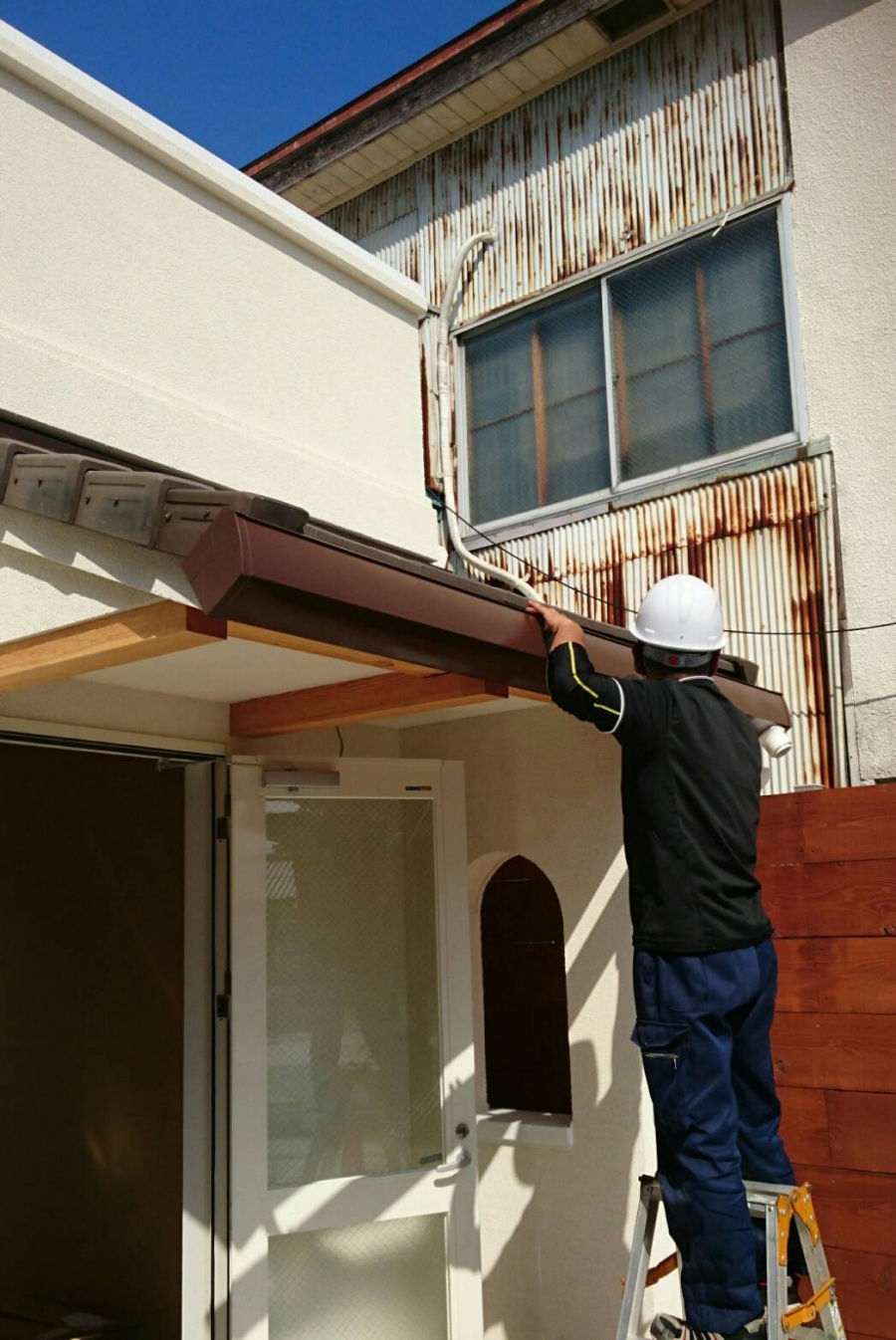 A様邸・A様店舗のポーチ1　ポーチの庇に雨樋を設置する作業