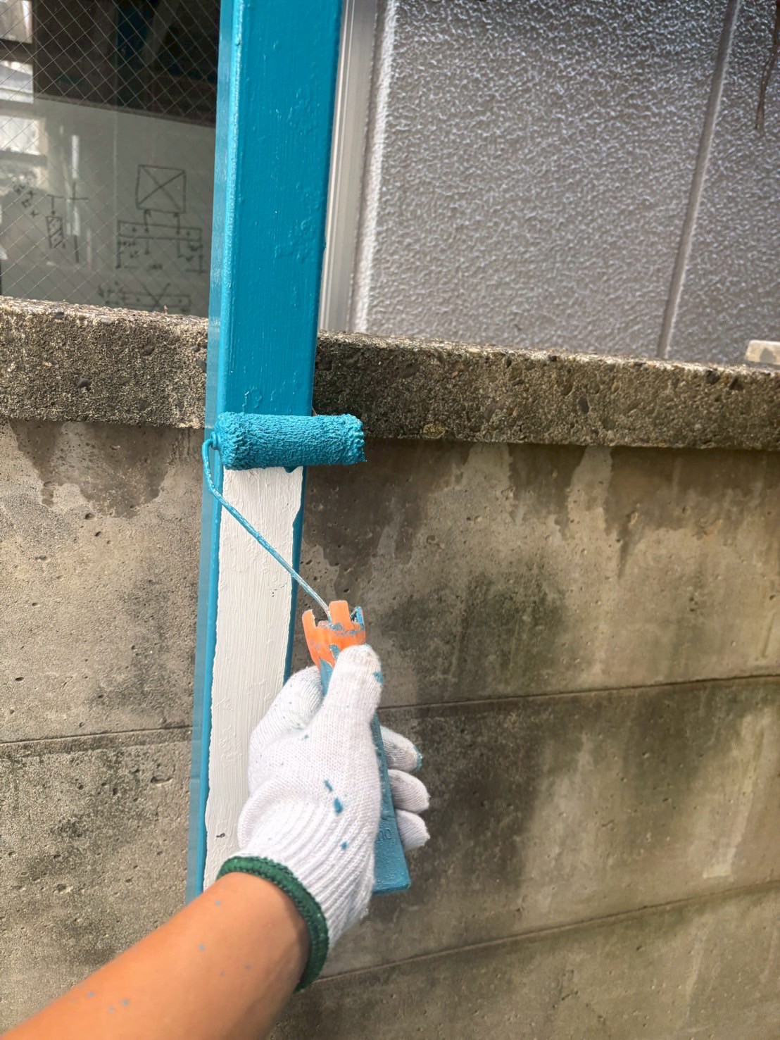 鉄骨を青い塗料で塗装中