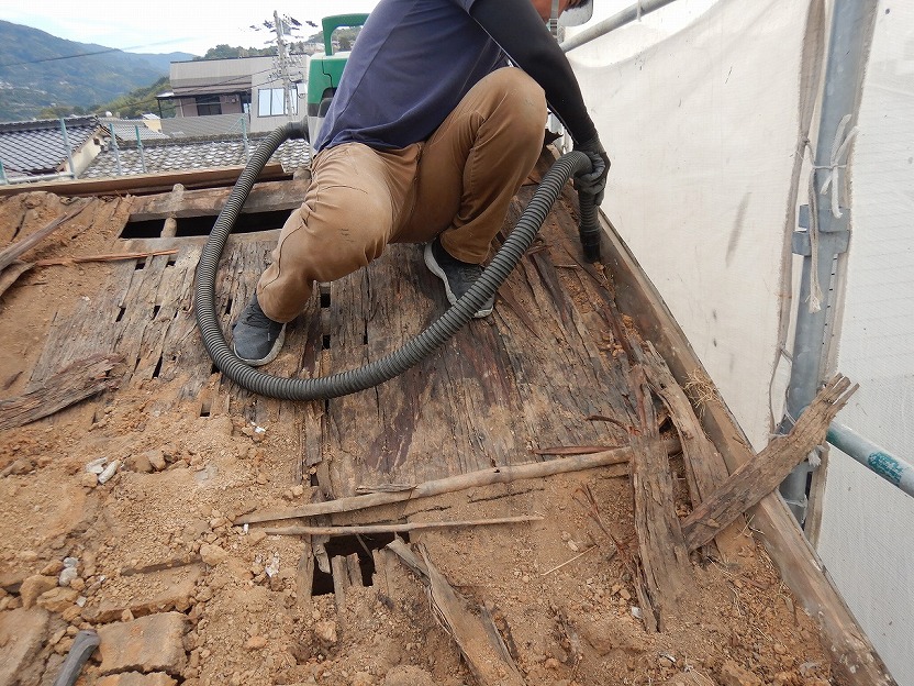 掃除機で土を掃除している様子