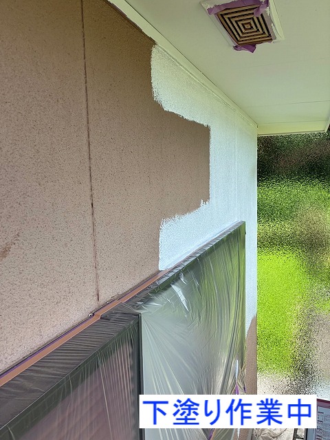 吹き付け外壁の下塗り作業中