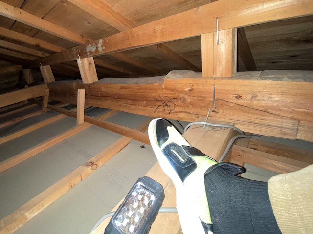 天井裏を渡り歩く職人の足