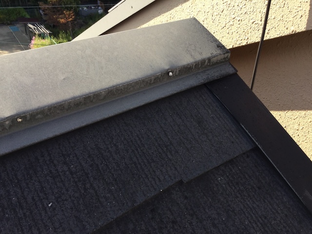 棟板金の変色と、釘が効かなくなって浮き始めている危険な状態。