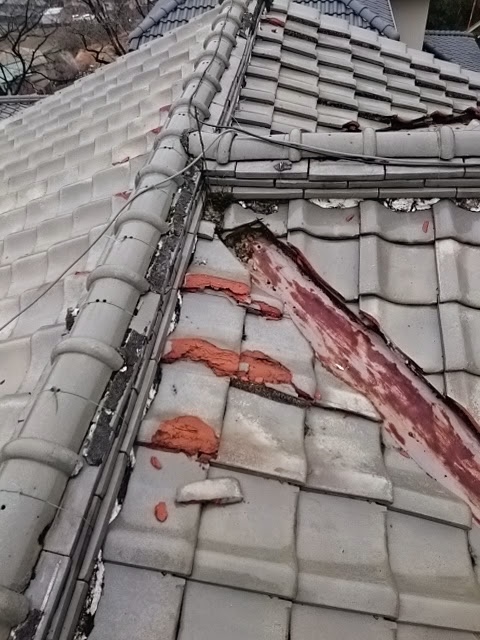 経年劣化により赤く変色し腐食が進んだ銅製の谷板金と瓦屋根の点検状況