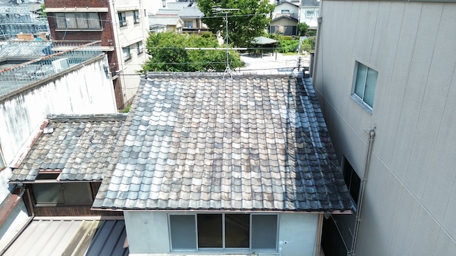 大屋根全体の空撮画像。瓦の並びやアンテナの状況、隣家との境界付近をドローンで確認