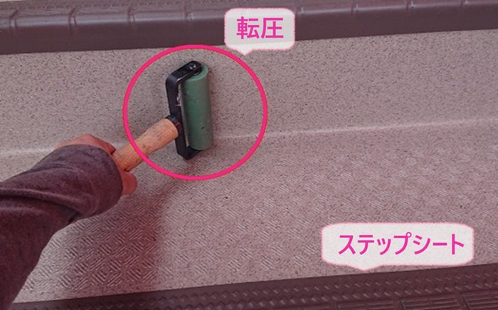 外部階段、廊下のメンテナンス工事で階段にステップシートを貼っている様子