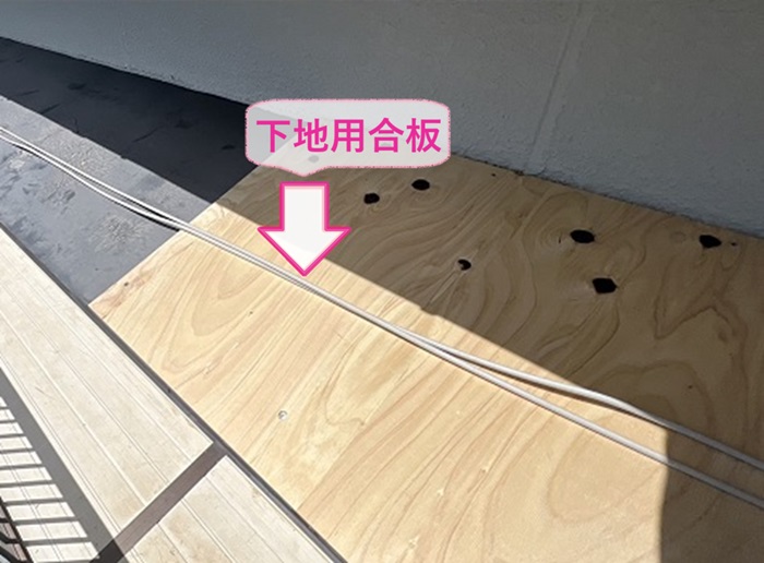 小庇と幕板の修繕工事で既存の小庇の上から下地用合板を増し貼りしている様子