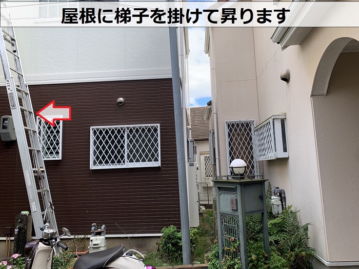 塗膜の剥がれを確認するために屋根に梯子を掛けている様子