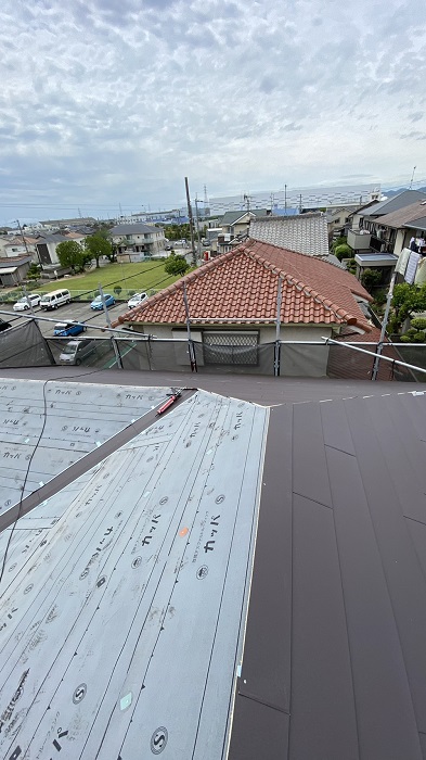 屋根重ね葺き工事で屋根ふきをしている様子