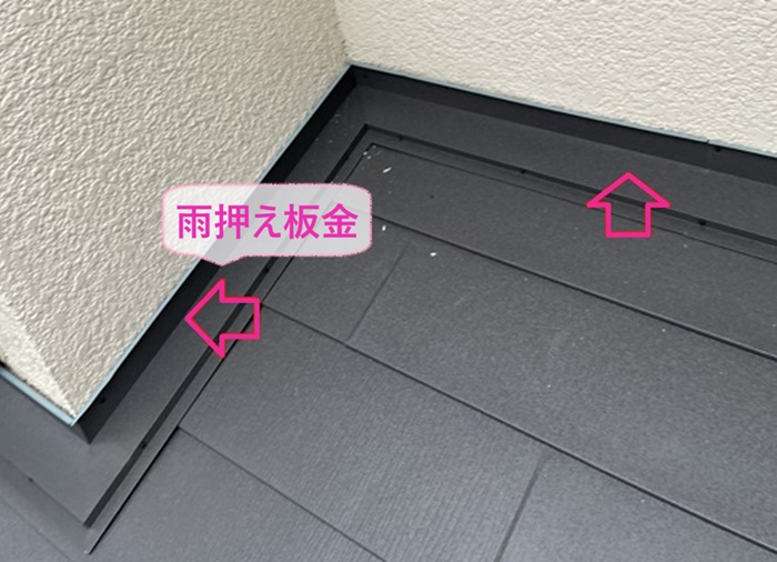 M型スレート屋根リフォームで壁際に雨押さえ板金を取り付けている様子