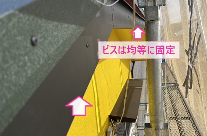 木製破風板への板金カバー工事でビスを均等に固定している様子