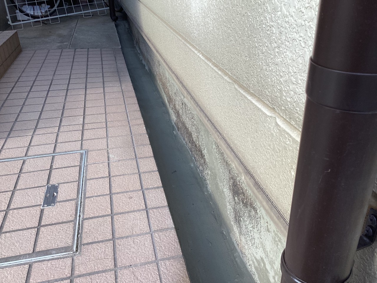 外部の水漏れしている側溝をセメントで修理した様子