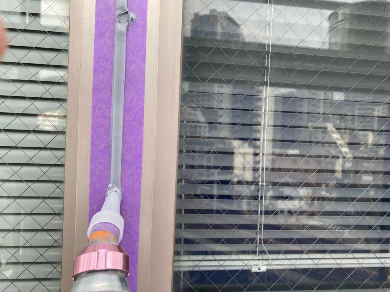 神戸市中央区でのコーキング打ち替え工事でサッシ廻りにコーキングを流している様子