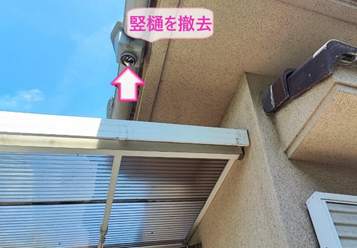 ２階部分の軒樋の部分補修で既存の竪樋を撤去して内部を掃除している様子