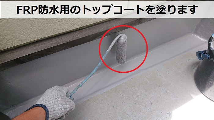 剥がれたベランダ防水工事でトップコートを塗っている様子