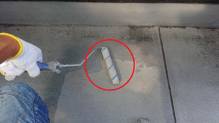 ベランダ床にプライマーを塗っている様子