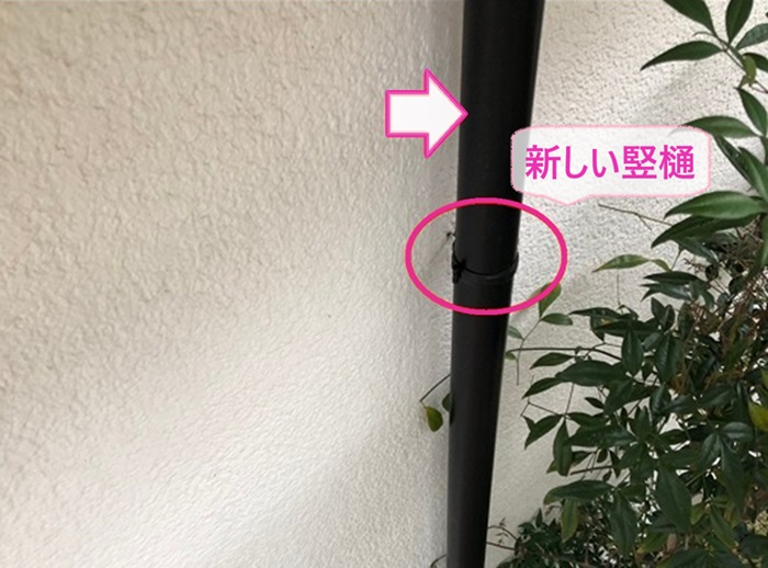 一軒家の雨樋取り替え工事で新しい竪樋を取り付けている様子