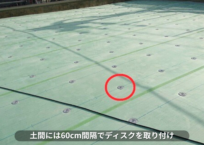 南あわじ市 ンション屋上防水工事の塩ビシート機械固定工法でディスクを取り付けている様子